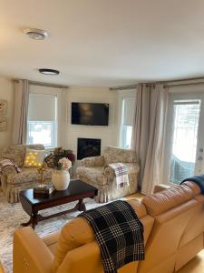 a living room with a couch and a table at The Beaverpond Getaway Suite in Brigus +14 photos