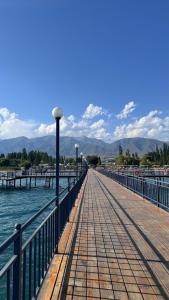 a pier with a view of the water and mountains at Коттедж в ЦО Атлантис in Chon-Sary-Oy