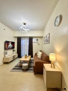 a living room with a couch and a table at 2-Bedroom Condo Unit with Balcony at Centrio Tower beside Ayala Centrio Mall Downtown CDO in Cagayan de Oro