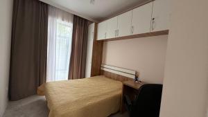 a small bedroom with a bed and a window at Коттедж в ЦО Атлантис in Chon-Sary-Oy