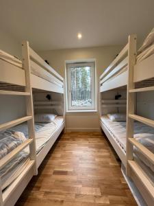 two bunk beds in a room with a window at Modern Mountain Cabin in Idre 1022 in Idre
