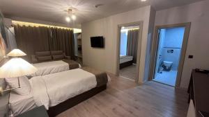A bed or beds in a room at SAR-PER Hotel