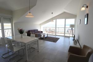 a living room with a white table and chairs at Adriadome Apartments in Bijela