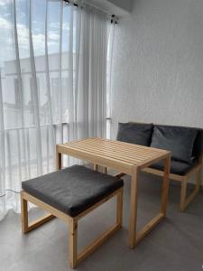 a table and a bench and a table and a couch at Коттедж в ЦО Атлантис in Chon-Sary-Oy