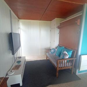 a small room with a bed and a flat screen tv at Chalet Lestraouen in Plougastel-Daoulas