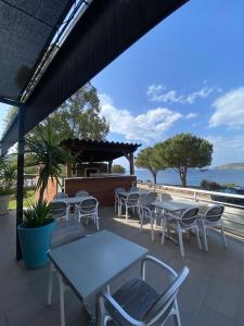 a group of tables and chairs on a patio at Hotel Restaurant Le Filosorma in Galeria +21 photos