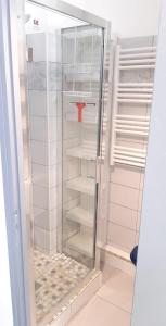 a glass refrigerator with a red object in it at Héliopolis F9 in Cap d'Agde