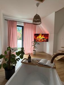 Televízia a/alebo spoločenská miestnosť v ubytovaní ApartSki 18d