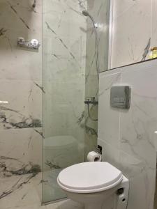 a bathroom with a toilet and a glass shower at Jasmine Apartment in Rafailovici