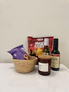 a table with two bottles of wine and a basket of food at Jasmine Apartment in Rafailovici