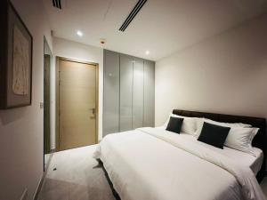 a bedroom with a large white bed with pillows at The address, Colombo in Colombo +12 photos