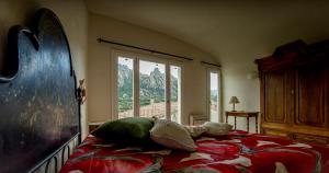 a bedroom with a bed with a view of a mountain at Antica Dimora La Corona in San Pantaleo