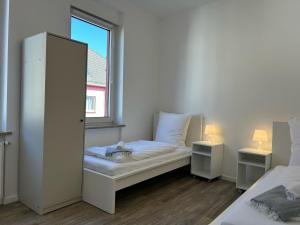 a small room with a bed and a window at Convenient Apartment for 3 in Offenbach