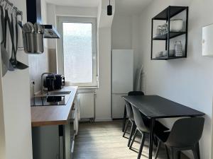 a kitchen with a table and chairs and a sink at Convenient Apartment for 3 in Offenbach