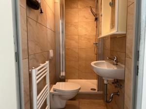 a small bathroom with a toilet and a sink at Convenient Apartment for 3 in Offenbach