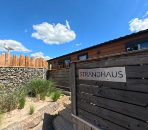 a sign on a fence in front of a building at Rhönstrand in Wartmannsroth