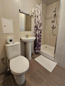 a bathroom with a toilet and a sink and a shower at ----------------------------- Via Baltica Panevezys in Panevėžys +28 photos