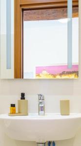 a white bathroom sink with a window above it at Da Rocky in Riomaggiore