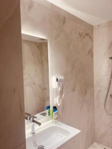 a bathroom with a sink and a shower and a mirror at SARANDA Vila HM in Sarandë +149 photos