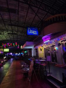 a restaurant with tables and chairs and a blue sign at Dorothys in Pattaya South