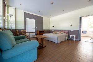 a hotel room with a bed and a couch at Gite Le Relais Saint Michel in Domfront