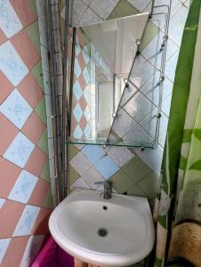 a bathroom with a sink and a mirror at like at home in Yalanghoch