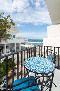a table on a balcony with a view of the ocean at Sophisticated Paros Getaway in Parikia