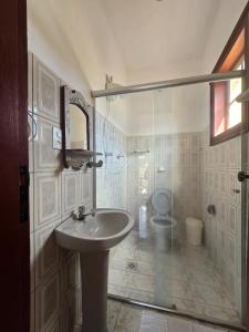a bathroom with a sink and a toilet at Pousada Padre Toledo in Tiradentes