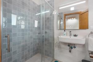 a bathroom with a sink and a glass shower at La Casa de Rita in Garachico +11 photos
