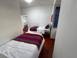 Postel nebo postele na pokoji v ubytování Mallku Wasi - Lodging Hotel Cusco