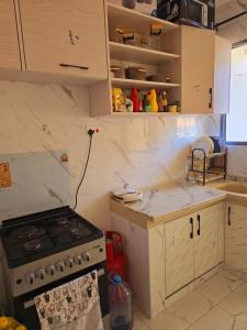a kitchen with a stove and a counter top at Vee stays in Mombasa