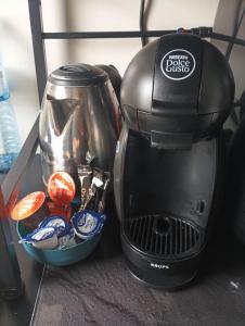 a coffee maker sitting next to a bowl of food at flowers room au coeur de saint Ouen parking gratuit in Saint-Ouen