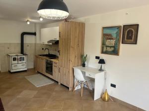 a kitchen with a table and a desk in a room at Villa Markisa in Rukavac