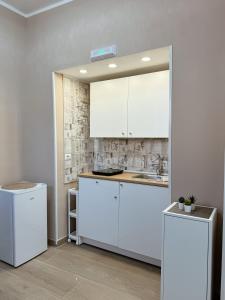 a kitchen with white cabinets and a sink at Nonno Ciro B & B in Torre Annunziata +10 photos