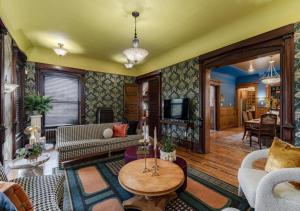 a living room with a couch and a table at Akrons Werner House Historic 4 Bedroom Luxury in Akron