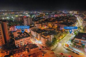 an aerial view of a city at night at Antalya Residence Hotel in Antalya