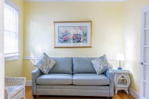 a living room with a couch and a picture on the wall at Deluxe King with Balcony - at James House with Parking! in Key West