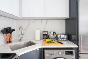 a kitchen with a sink and a counter top at 78-4A 2BR Duplex with a Balcony Prime UES in New York +22 photos