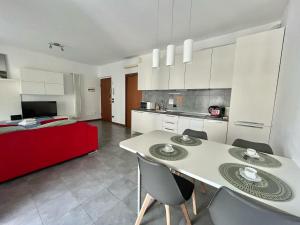 a kitchen and living room with a table and chairs at Santa Giulia Terrace - 15 Mins City Center in Linate