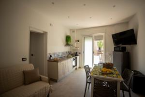 a kitchen and living room with a table with fruit on it at Umberto Home 303 in Catania
