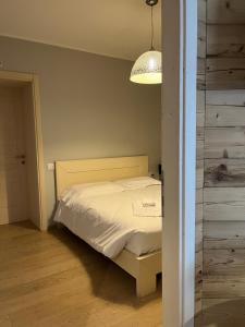 a small bedroom with a bed with a light at Casa Vacanze Ranuncolo 1 in Sùtrio