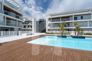an image of an apartment building with a swimming pool at Homiday - WaterFront Roseto in Roseto degli Abruzzi