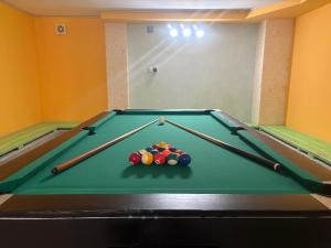 a pool table with cue balls on top of it at Villa YoSi - rooms in Sapareva Banya