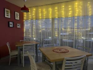 a dining room with tables and chairs and a window at Villa YoSi - rooms in Sapareva Banya +16 photos
