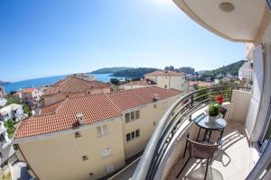 a balcony with a table and a view of a city at Apartments Charme in Bečići