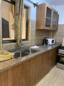 a kitchen with a sink and a microwave at One Bedrooms 230 Heron Drive Nyari Estate in Nairobi