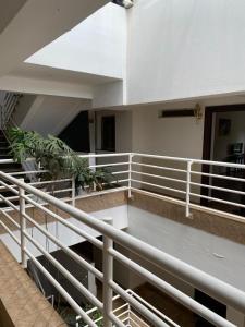 a balcony of a building with a white railing at One Bedrooms 230 Heron Drive Nyari Estate in Nairobi