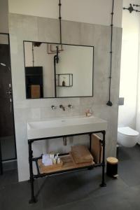 a bathroom with a white sink and a toilet at Watertoren Hengelo in Hengelo