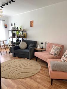 a living room with two couches and a table at Cosy Flat in Ludza