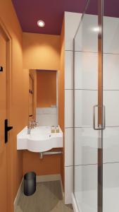 a bathroom with a sink and a shower at Unisotel Lyon Bron Eurexpo in Bron +28 photos